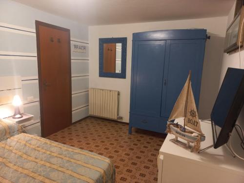 a bedroom with a bed and a toy boat on a dresser at Verahouse in Viareggio