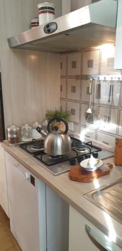 a kitchen with a stove with a tea kettle on it at Verahouse in Viareggio