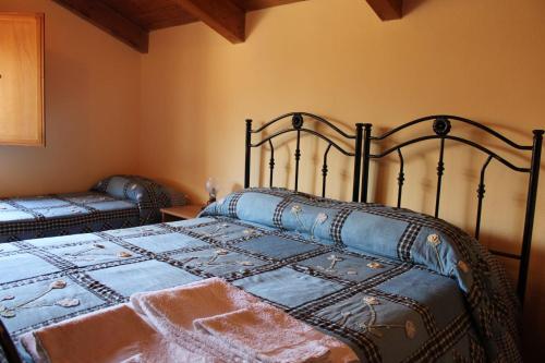 a bedroom with a bed with a blue comforter at Agriturismo La Pigna in Corigliano Calabro