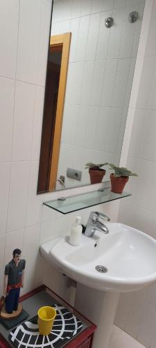 a bathroom with a sink and a mirror at Cozy room near Las Teresitas beach in Santa Cruz de Tenerife
