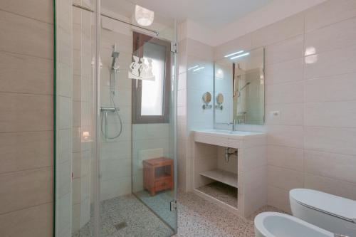 a bathroom with a glass shower and a sink at Le tre zie B&B in Manduria