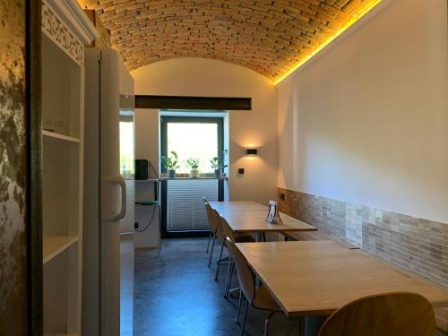 a dining room with wooden tables and a window at Black House 88 in Ustroń