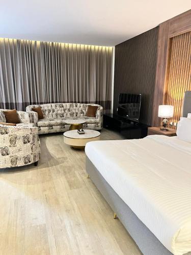 a hotel room with a bed and a couch at Arayik Resort in Taif