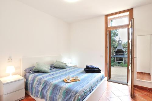 a white bedroom with a bed with a tray on it at Isola Blu, Jacuzzi & Pool by DomusAway in Porto San Paolo