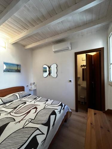 a bedroom with a bed with a black and white comforter at Borgo degli Svevi rooms in Bari