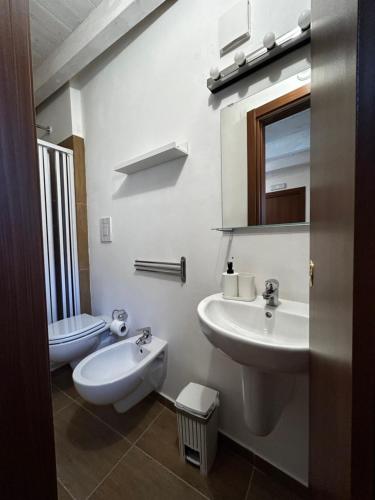 a bathroom with a sink and a toilet and a mirror at Borgo degli Svevi rooms in Bari