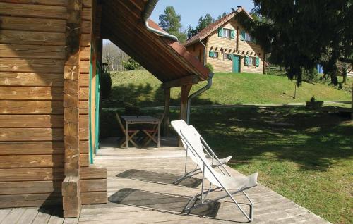 a white chair sitting on a patio next to a house at 2 Bedroom Awesome Home In Saulxures in Saulxures