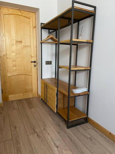 a book shelf in a room with a door at Sargsyan ECO house in Sevan