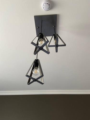 a black chandelier hanging from a ceiling at Sargsyan ECO house in Sevan