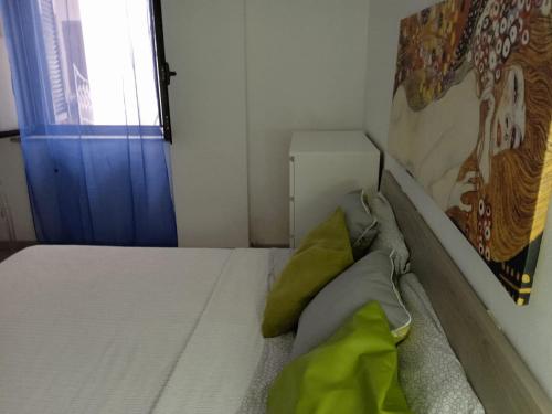 a small bedroom with a bed with green pillows at Casaagnese in Catania