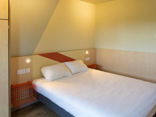 a large white bed in a small room at ibis budget Tours Sud in Chambray-lès-Tours