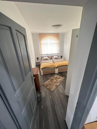 a bedroom with a bed and a window at Rena Vendégház in Nagykanizsa