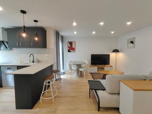 a kitchen and living room with a couch and a table at Fantastic apartment Sant Adria Beach in Sant Adria de Besos
