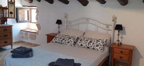 a bedroom with a bed with two pillows on it at Cortijo el Moro in Vélez Blanco