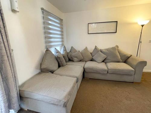 a living room with a couch and a window at Cosy One Bedroom Flat in London in North Woolwich