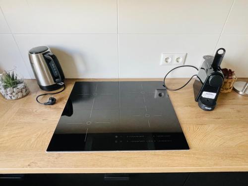 a kitchen counter with a laptop on a counter top at Juniorsuite-Apartment Weiden in Weiden