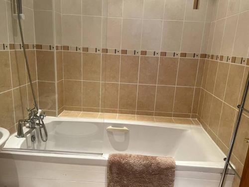 a bath tub in a bathroom with a sink at Cottage in Par, 4mi. from Fowey in Saint Blazey