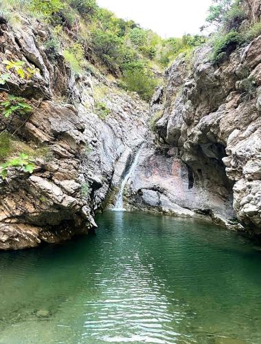 a small pool of water in a rocky river at Old Town Bar Apartments in Stari Bar