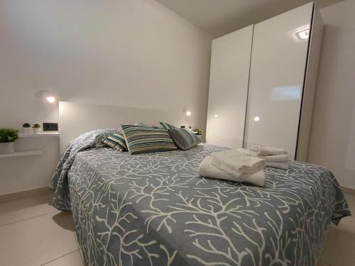 a bedroom with a large bed with two pillows at La Maison Des Arches in Porto Cervo
