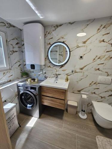 a bathroom with a sink toilet and a mirror at Shtorya - city centre apartman in Split