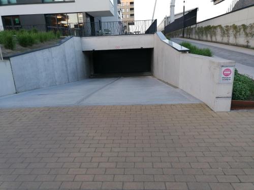 a parking garage in the middle of a building at Bartine - modern and spacious flat near the sea, free parking space in Ostend