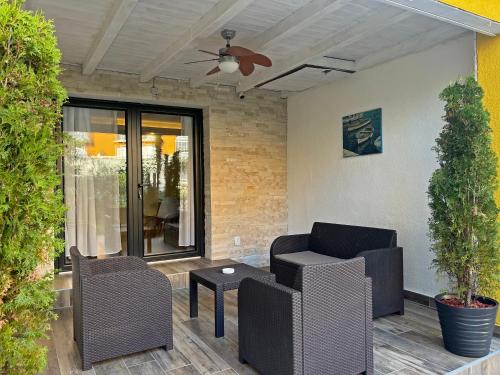 a patio with two chairs and a ceiling fan at Apartments Center Opatija Ziric in Opatija