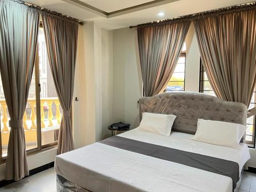 a bedroom with a bed in front of a window at Northern Suites Bahria town in Rawalpindi