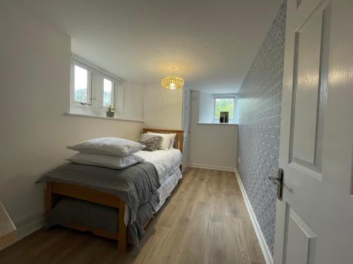 a small bedroom with a bed and a window at Wookey Hole Hideaway in Wookey Hole