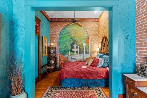 a bedroom with a bed in a brick wall at The Peerless Hotel in Ashland