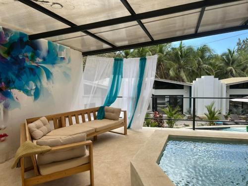 a patio with a couch and a swimming pool at Puerta Negra in Playa Flamingo