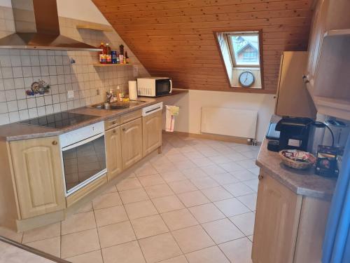 a kitchen with a sink and a stove top oven at Dachwohnung in Welschenrohr in Welschenrohr