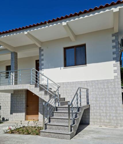 a house with stairs in front of it at Zani GuestHouse in Fier