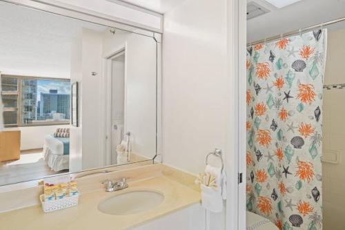 a bathroom with a sink and a mirror at Ka Maluhia Suite, 1 Bed 1 Bath & 1 Free Parking in Honolulu