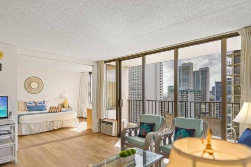 a hotel room with a bed and a balcony at Ka Maluhia Suite, 1 Bed 1 Bath & 1 Free Parking in Honolulu