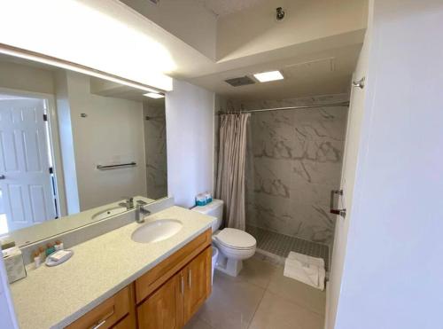 a bathroom with a sink and a toilet and a mirror at Lë'ahi Diamond Head Suite 1 Bedroom 1 Free Parking in Honolulu