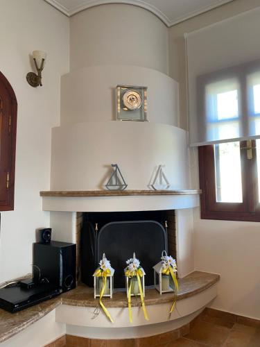 a living room with a fireplace with bows on it at La Grande Maison,Lefokastro in Afissos