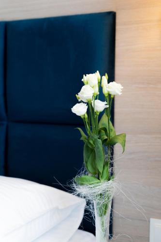 a vase filled with white flowers sitting on a table at Lynks Resort in Ustrzyki Dolne