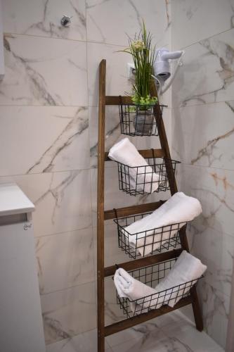 a bathroom with a wooden towel rack with towels at Papachristos Villa in Prinos