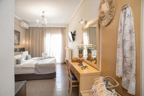 a hotel room with a bed and a mirror at Hotel Pithari in Agia Triada