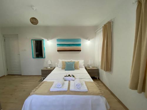 a large bedroom with two beds with towels on them at Lemon-Ada Butik Otel in Kusadası