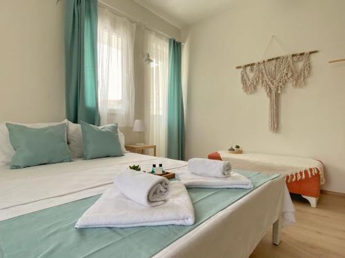 a bedroom with two beds with towels on them at Lemon-Ada Butik Otel in Kusadası