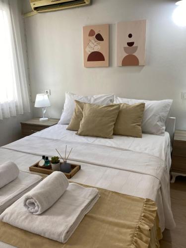 a large white bed with two towels on it at Lemon-Ada Butik Otel in Kusadası