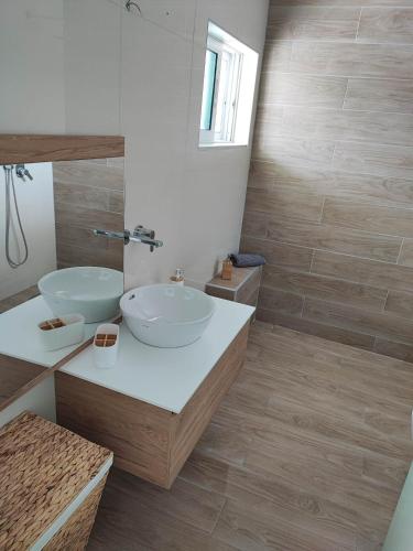 a bathroom with two sinks and a mirror at Elia Small Paradise in Kos