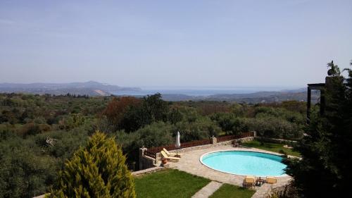a swimming pool in the middle of a yard at Stratos Villas in Melidhónion