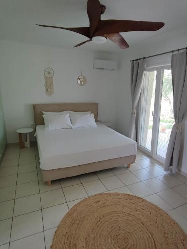 a bedroom with a bed and a ceiling fan at Elia Small Paradise in Kos