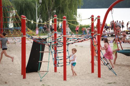 a group of children playing on a playground at DW Turysta in Licheń Stary