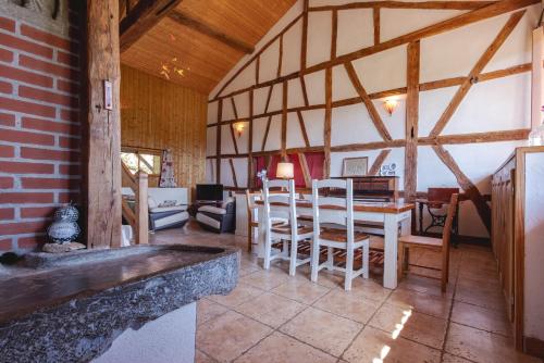 une salle à manger avec une table et des chaises dans une pièce dans l'établissement Longère bressane de la Verne, à Cormoz