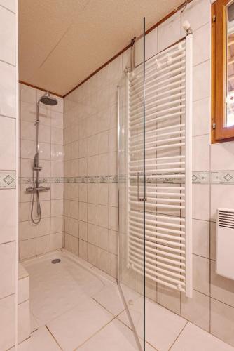 a bathroom with a shower with a glass door at Longère bressane de la Verne in Cormoz
