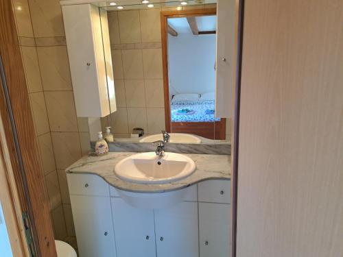 a bathroom with a sink and a mirror at Holiday Home Pernat in Valun