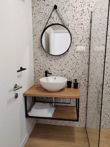 a bathroom with a sink and a mirror at Villa Panama in Pag